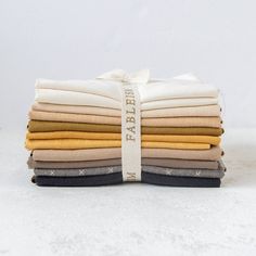 a stack of folded clothes on top of each other