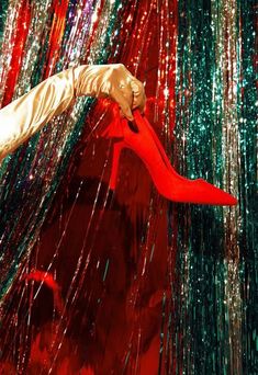 a woman in red and white is dancing with streamers