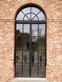 an old brick building with arched glass doors