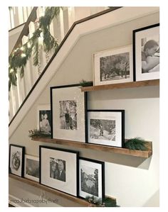 the stairs are decorated for christmas with pictures and garlands on them, along with pine cones