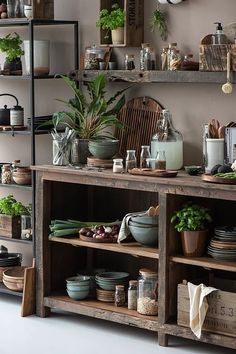 the shelves are filled with pots, pans and other kitchen utensil items