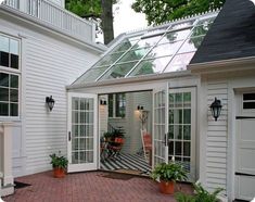 a white house with an orange brick patio