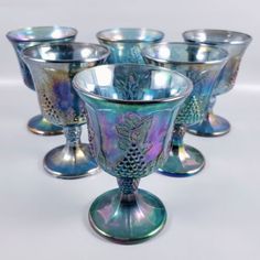 six glass goblets sitting on top of each other