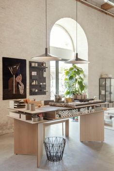 a kitchen with an island and hanging lights