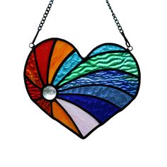 a stained glass heart hanging from a chain