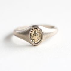 Virgin Mary signet ring
 Gorgeous minimalist Mary signet ring. DETAILS Band   Style: Minimalist Material:   14k Gold: yellow, white, rose  18k Gold: yellow, white, rose  Other Metal: platinum  Measurements: Mary measures 7x5mm approx
   Sizing: We are using US metric system  Customization Options This design can be made with gemstones of your choosing. If you would prefer a custom ring, please contact us before purchase. Procedure Information  Please select the material and ring size from the dr Minimalist Initial Ring In Polished White Gold, 14k Gold Signet Ring With Smooth Bezel For Gift, 14k Gold Signet Ring With Smooth Bezel As Gift, White Gold Signet Ring With Smooth Bezel, Timeless White Gold Signet Ring, Tarnish Resistant, Minimalist Hallmarked White Gold Initial Ring, Minimalist Open Signet Ring With Engraving Option, Minimalist White Gold Dome Ring, Tarnish Resistant, Minimalist White Gold Dome Ring Tarnish Resistant