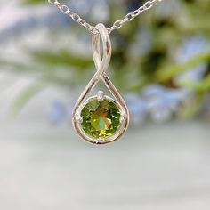 "Natural Peridot infinity necklace is a great gift for mom, her, wife, and daughter, perfect for August birthdays. A dainty and elegant piece of jewelry! If you are looking for a Natural Peridot Pendant Necklace, August Birthstone Necklace, Infinity Necklace With Birthstone, this necklace is a perfect choice. Item Detail: - Gemstone: Natural Peridot - Stone Size: 8mm Round Cut - Shape: Infinity - Material: S925 Silver - Chain: 18\"-20\" (Leave me a note if you need a longer chain). Why choose Peridot Necklace: - The necklace is handmade, and the stone is selected with perfect quality. - Peridot is believed to bring good health, restful sleep, and peace to relationships by balancing emotions and mind. - Minimalist, elegant design is an excellent gift for your mother, girlfriend, and daughte August Birthstone Necklace, Infinity Necklace Silver, Peridot Pendant, Peridot Necklace, Emerald Bead, Peridot Stone, Art Deco Pendant, Infinity Necklace, Great Gifts For Mom