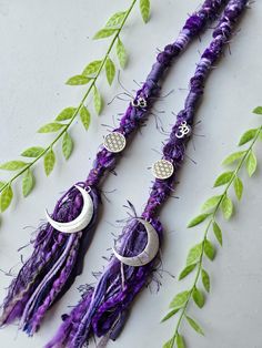 Hair Wrap with Moon, Om and Sacred Geometry Seed of Life Charms. Deep mixed dark purple, Witchy Fairy Lock Dread Extension Loop into Dreadlocks or Braid into regular hair Video link with instructions: https://www.instagram.com/reel/CeddwyzIj3I/?igshid=YmMyMTA2M2Y= See my other listings / Etsy Page www.lionheartdreadlocks.etsy.com  For other 🦁Dreadlock and Braid Accessories 🐆Necklaces and Earrings 🦁Crystal Accessories 🐆Hair Wraps  🦁Fairy Locks 🐆Hand Knitted Scarves 🦁And other Hippy, Viking Fairy Locks, Witchy Accessories, Hand Knitted Scarves, Braid Accessories, Dread Extensions, Accessories Necklaces, Dreadlock Extensions, Knitted Scarves, Seed Of Life