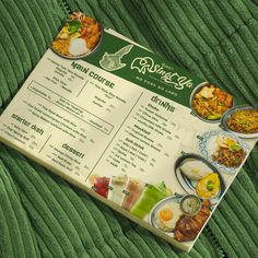 a restaurant menu sitting on top of a green blanket