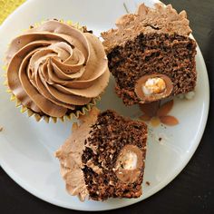 three cupcakes on a plate with the words creme egg cupcakes