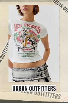 Baby tee with a Les Tigres printed at the front. Hits at the waist in a cropped silhouette with a crew neckline and cap sleeves. Find it exclusively at Urban Outfitters. Features Les Tigres graphic baby tee Tee with a Les Tigres graphic at the front Cropped silhouette Crew neckline UO exclusive Content + Care 100% Cotton Machine wash Imported Size + Fit Model in White is 5’10" and wearing size Small Measurements taken from size Small Chest: 24" Length: 17" | Les Tigres Baby Tee in White, Women's at Urban Outfitters Fitted Cropped T-shirt With Logo Print, Crew Neck Crop Top With Logo Print For Streetwear, Fitted Cotton Cropped T-shirt With Graphic Print, Trendy Cropped Crew Neck T-shirt With Logo, Logo Print Cropped T-shirt For Spring, Spring Cropped T-shirt With Logo Print, Cropped Logo Print T-shirt For Spring, Fitted Graphic Cropped T-shirt With Crew Neck, Sporty Fitted Top By Urban Outfitters