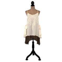 This layered dress features spaghetti straps crossed at the back and a romantic boho, mori vibe. The lace applique on the bodice and side ties also add a 20's style flapper feel to this unique loose fitting chemise. I love the creamy beige and brown combo and the high low hemline. Also available in Blue/Gray here: https://www.etsy.com/listing/656680524/romantic-clothes-layered-dress-boho-mini?ref=shop_home_active_7 Each piece in our HEART ALTERED collection has been embellished with our signatur Bohemian Dress With Lace Patchwork And Spaghetti Straps, Bohemian Spaghetti-strap Dress With Lace Patchwork, Bohemian Dress With Spaghetti Straps And Ruffles, Bohemian Spaghetti Strap Dress With Ruffles, Bohemian Sleeveless Dress For Layering, Bohemian Sleeveless Boho Dress With Lace Trim, Bohemian Boho Dress With Lace Trim Sleeveless, Bohemian Lace Trim Camisole For Beach, Bohemian Lace Trim Camisole For Vacation