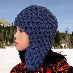 a woman wearing a blue crocheted hat in the snow