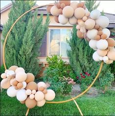 a circle made out of eggs sitting on top of grass next to a house and trees