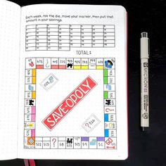 an open notebook with a monopoly game on it