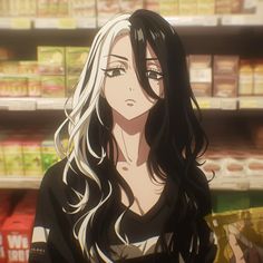 a woman with long hair standing in front of shelves