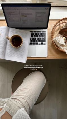 a person sitting at a desk with a laptop and coffee in front of them on their lap