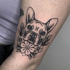 a dog is shown with flowers on his arm