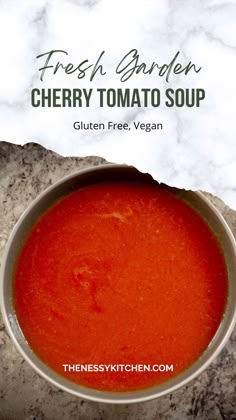 fresh garden cherry tomato soup in a bowl on a marble surface with the title overlay