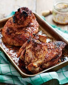 two pieces of meat sitting on top of a pan