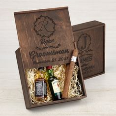 two wooden boxes with cigars and bottles in them