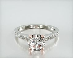 a diamond engagement ring on a white background