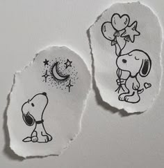 two pieces of torn paper with drawings of dogs and stars on them, one has a balloon in the shape of a heart