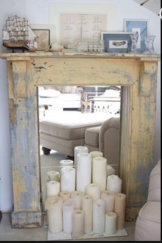 a mirror sitting on top of a mantle filled with candles