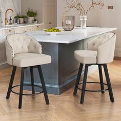 two stools at the center of a kitchen island