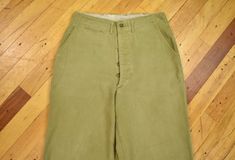 You are looking at a pair of cotton twill boyscout pants, circa 1940s.  This item is in perfectly "worn in" condition with some signs of usage throughout. Overall looks great. Please refer to measurements to ensure proper fit.  Size in title and description are based on actual measurements. Measurements (laying flat): 14" across at top of waist 29.5" inseam Vintage Cotton Chinos For Work, Vintage Wide Leg Cotton Work Pants, Retro Cotton Bottoms With Buttons, Cotton Vintage Straight Leg Cargo Pants, Vintage Straight Leg Cotton Cargo Pants, Vintage Cotton Straight Leg Cargo Pants, Vintage Cotton Cargo Pants For Workwear, Vintage Full-length Cotton Pants, Vintage Green Cargo Pants