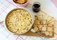 a bowl of dip and crackers on a table