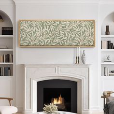 a living room filled with furniture and a fire place in front of a book shelf