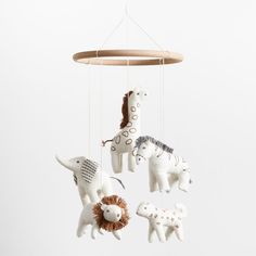 three toy animals are hanging from a mobile