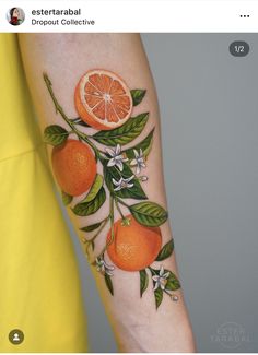 an orange on the arm with leaves and flowers