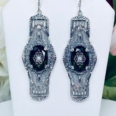 Inspired by the Art Deco movement of the early 1900s, I now offer these lovely 1920s reproduction earrings in sterling silver. Each stunning gemstone has a silver embellishment in the center. The gemstone is 14mm long (just over 9/16th") and 10mm in width (3/8"). The simulated gemstones have excellent color and clarity. The earrings are 2 1/2th inches long. Notice the beautiful design of the Deco filigree setting. Art Deco Movement, Gems Art, Early 1900s, Gemstone Earrings, Beautiful Design, Embellishments, Castle, Art Deco, Gems