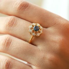 Sometimes when a girl says she likes to receive flowers as a gift, it's not the real flowers she means. Think twice and go for the safest thing - our Flora ring with London Blue Topaz with side moissanite. Floral jewelry is where it's at! Perfect as a graduation gift, birthday gift, anniversary ring, or a promise ring. Details: Center stone Gemstone: London Blue Topaz Stone Shape: Round Measurements: 5.00mm Side stones Gemstone: Moissanite Shape: Round Measurements: 1.30mm (8) Band measurements: Flowers As A Gift, Receive Flowers, Hand Jewelry Rings, London Blue Topaz Ring, Floral Jewelry, Blue Topaz Stone, Rose Quartz Ring, Gemstone Engagement, Agate Ring