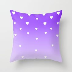 a purple and white pillow with hearts on it