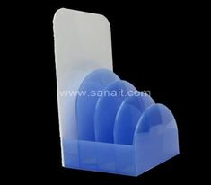 a blue plastic knife holder on a black background