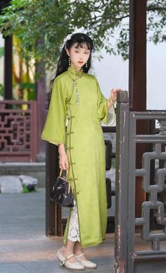 A satin qipao reminiscent of a fresh bamboo grove, the Liu Huang 柳黄 1930s Qipao is comfortable and soft for daily wear. Featuring 1930s style three-quarter bell sleeves, triple knot collar, and lower side slits, this dress can be styled up or down for any occasion. Vintage cut qipaos are designed to be looser around the waist, allowing them to be more comfortable than modern day cheongsams. It is recommended to add 2-3cm to your measurements to ensure you get the correct vintage fit. This item h Bamboo Grove, Cheongsam Modern, Modern Qipao, 1930s Style, Chinese Traditional Clothing, Hanfu Dress, Qipao Dress, 1930s Fashion, Vintage Fits