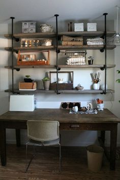 an office with shelves and desk in it