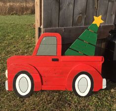 a wooden toy truck with a christmas tree in the back