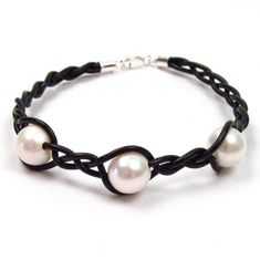 Beautiful and elegant genuine fine quality cultured fresh water white pearl braided leather cord bracelet    Pearls: 3 fine quality genuine cultured fresh water white pearls    Pearl measurement: approx. 8.5-9mm in diameter    Pearl shape: round to slightly off round    Luster: high    Color: white with possible slight pink or cream overtones    Surface: some minor surface clouds    Cord type: genuine black leather at 1.5mm in thickness    Clasp: 925 sterling silver lobster clasp    Bracelet mea Elegant Braided Leather Bracelets, Elegant Adjustable Braided Jewelry, Elegant Braided Leather Bracelet, Elegant White Leather Jewelry, Elegant Round Adjustable Leather Bracelet, Bracelet Pearls, Pearl Birthstone, Leather Cord Bracelets, Tahitian Black Pearls