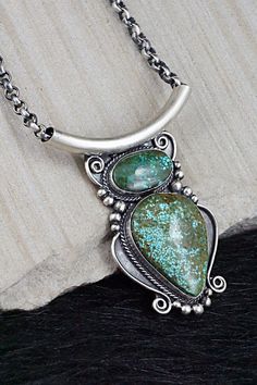 This stunning natural Kingman turquoise and sterling silver necklace was made by Navajo silversmith Raymond Delgarito. The back is signed RD and stamped sterling.Necklace: 16"Pendant Length: 2 1/2"Pendant Width: 1 1/2"Bead Size: 3/16" (6mm)Free shipping on all orders! We ship with USPS and always include tracking. All orders ship within a day of payment.Returns are accepted up to 30 days after you receive your order. Just send us a message. Our shop offers cash back or store credit. The item mus Bohemian Sterling Silver Turquoise Necklace With Patina, Collectible Sterling Silver Turquoise Necklace With Patina, Sterling Silver Turquoise Necklace With Patina, Bohemian Sterling Silver Necklace With Patina, Unique Turquoise Necklace Stamped 925, Southwestern Chrysocolla Pendant Necklace, Untreated Bohemian Turquoise Necklace For Collectors, Southwestern Silver Necklace With Patina, Untreated Southwestern Turquoise Pendant Necklace