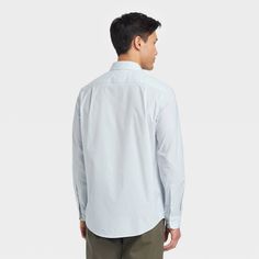 From work meetings to evening outings, stay cool, comfy and stylish in this Performance Dress Long-Sleeve Button-Down Shirt from Goodfellow & Co™. Tailored in a standard fit, this button-down shirt is crafted from a soft fabric blend with a hint of spandex for stretchy comfort. Designed with a collared neckline for classic style, you can wear it tucked in with dress pants or chinos with loafers or dress shoes for a special event, or sport it untucked with jean shorts or chambray pants for a more Casual Button-up Dress Shirt For Spring, Casual Spring Button-up Dress Shirt, Relaxed Fit Button-up Dress Shirt For Business, Casual Long Sleeve Dress Shirt With Buttons, Casual Button-up Dress Shirt For Work, Casual Dress Shirt With Button Cuffs For Work, Casual Dress Shirt With Button Cuffs For Fall, Casual Business Dress Shirt With Buttons, Casual Fall Dress Shirt With Button Cuffs