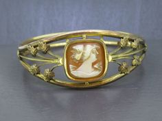 Beautiful antique cameo bracelet, not marked gold filled but tested and guaranteed.  Has light age related wear and patina.  Interesting clasp type, never seen it before but it works great.  Carved cameo looks great! Visit Ribbons Edge for more great pieces of vintage and antique jewelry!  All items added to your cart at Ribbons Edge will automatically combine shipping. To stay up to date with my newest offerings, follow me on IG @ RibbonsEdge Luxury Gold Cameo Bracelet, Vintage Adjustable Cameo Bracelet, Victorian Etched Gold Bangle, Luxury Vintage Gold-tone Bracelets, Vintage Bracelets 19th Century, Cameo Bracelet, Antique Gold, Antique Jewelry, Gold Filled