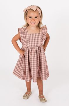 Bold ruffles bring playful energy to this adorably checked dress with a flared skirt that will look precious on your kiddo. Cotton lining 100% polyester Hand wash, line dry Imported Gingham Dress With Ruffled Hem And Straps, Picnic Dress With Ruffle Hem And Straps, Cute Ruffled Strap Dresses For Picnic, Gingham Dress With Ruffled Straps And Details, Gingham Dress With Ruffled Straps And Ruffles, Playful Gingham Dress For Playtime, Playful Gingham Dress With Ruffles, Gingham Dresses With Ruffles For Picnic, Cotton Gingham Plaid Dress With Ruffles