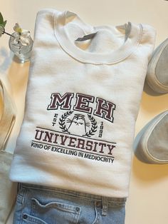 MEH University Embroidered Sweatshirt , True To Size, Unisex Sizing. Perfect For Fall! MEH University Embroidered Sweatshirt | Meh Sweatshirt | College Crewneck | Meh | Funny Sweatshirt | Cute Sweatshirt | Back To School Crewneck Design Ideas, University Hoodies, Crewneck Aesthetic, Hoodie Design Ideas, College Crewneck Sweatshirts, College Crewneck, Apparel Design Inspiration, College Sweater, Kawaii Sweatshirt