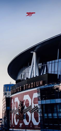 an airplane is flying over the emirates stadium