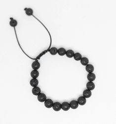 Black lava stone is perfect for those that love their essential oils! This unisex bracelets makes a great gift and is perfect for everyday.  This bracelet adjusts to fit most wrist sizes with string pull Lava stone is known as a calming stone and is great for strength and courage. Add a drop or two of essential oils to these porous stones to get extra healing effects. Comes in linen gift pouch with artist card. Essential Oil Bracelet, Lava Stone Bracelet, Artist Card, Diffuser Jewelry, Diffuser Bracelets, Unisex Bracelets, Bracelet Black, Healing Bracelets, Lava Stone