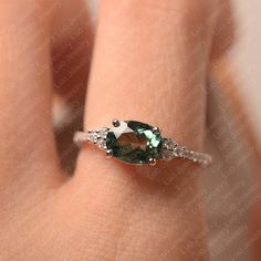 This ring features a 6*8 mm oval cut lab green sapphire. Customization is available. It is made by hand, and it will take about 7 days to finish the ring after your payment is completed. Main stone: 6*8 mm oval cut green sapphire Main stone weight: 1.75 ct Metal type: sterling silver /14k gold Accent stone: cz Customization is available, just fee free to contact me, it is free to engrave inside the ring, it is free, you can leave a ntoe with your order, but it will be great no more than 15 lette Green Oval Sapphire Promise Ring, Oval Green Sapphire Jewelry, Oval Sapphire Emerald Ring In Silver, White Gold Sapphire Ring, Green Sapphire Ring, Green Gemstone Ring, Sapphire Wedding Rings, Sapphire Wedding, White Gold Wedding Rings